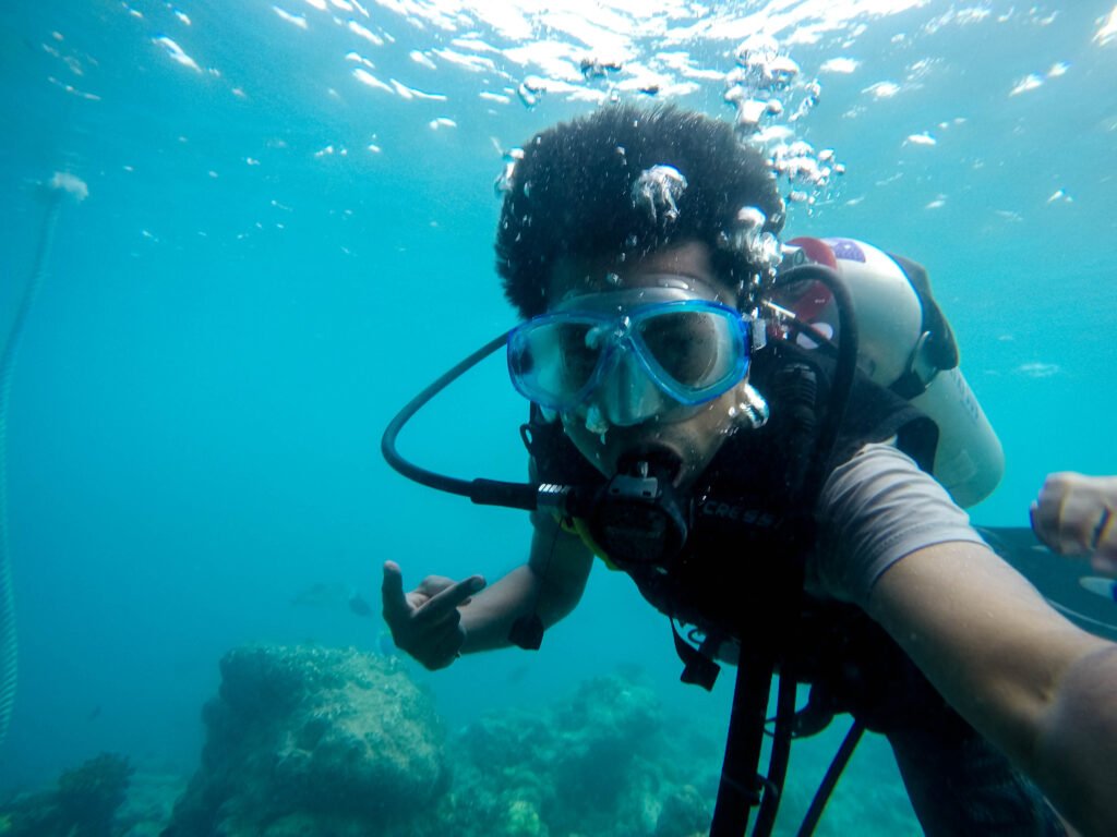 "An underwater selfie of a man scuba diving."