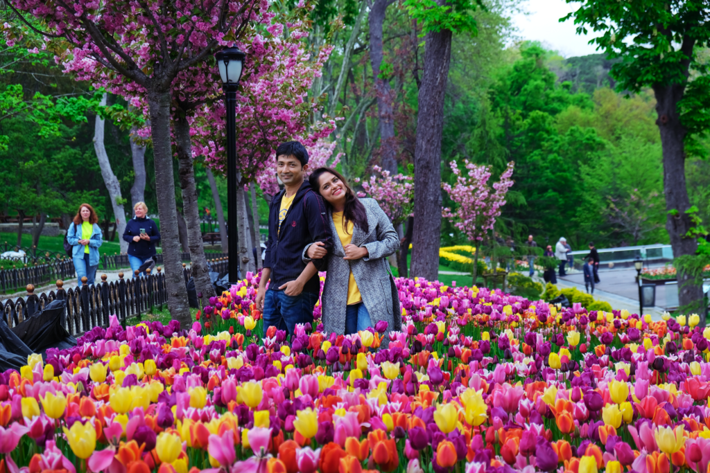 "A couple inside a Tulip garden."